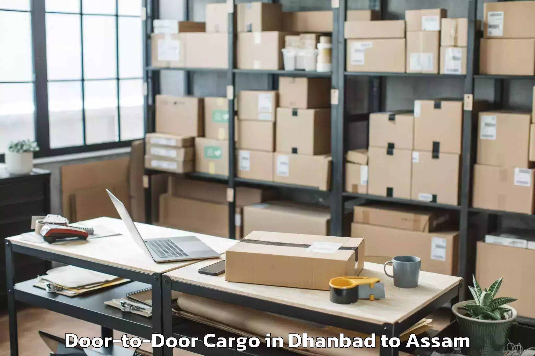 Easy Dhanbad to Darangamela Door To Door Cargo Booking